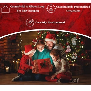 May include: A family of four, wearing Santa hats, are gathered around a Christmas gift box. The box is wrapped in red paper with a white bow. The family is sitting in front of a decorated Christmas tree with lights and ornaments.