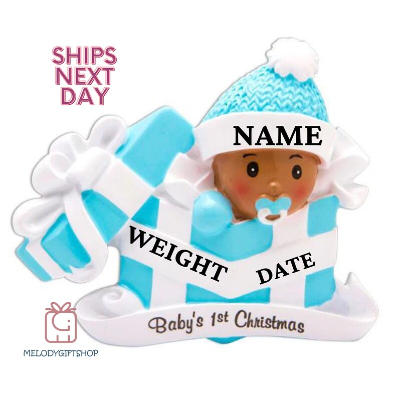 May include: Blue and white personalized baby's first Christmas ornament. The ornament features a baby in a blue hat and a blue and white striped onesie. The ornament has the words "NAME", "WEIGHT", "DATE", and "Baby's 1st Christmas" on it.