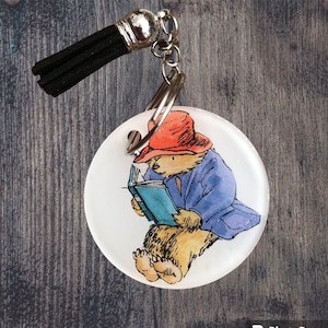 Paddington bear keyrings , keychains with vintage Paddington designs , different designs , bookbag keychains , Paddington gifts