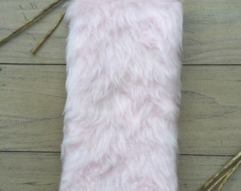 Pink fluffy fur fabric made into a glasses case and lined with hot pink lining. Wadding for padded protection and silver magnetic popper.