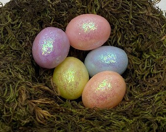 May include: Five pastel-colored Easter eggs with glitter, nestled in a bed of green moss.
