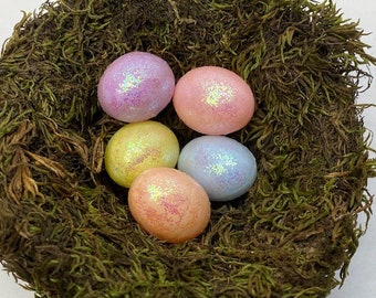 May include: Five pastel-colored Easter eggs with glitter, nestled in a bed of green moss.