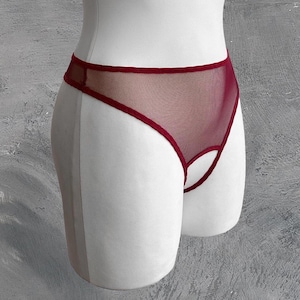 May include: Burgundy mesh lingerie with a keyhole cutout in the front.