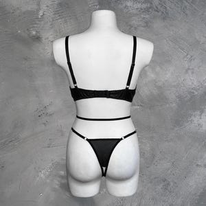May include: Black lingerie set with a lace bra and a sheer panty with a delicate design.
