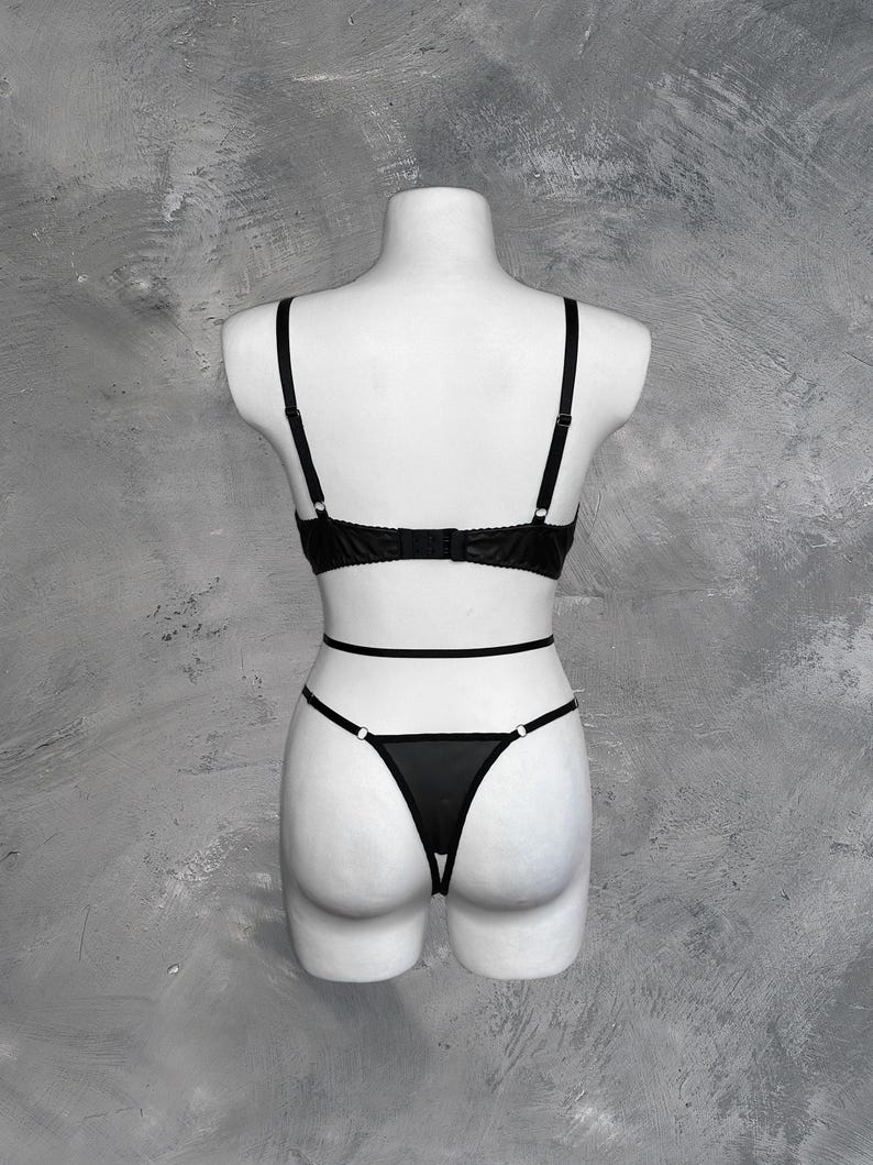 May include: Black lingerie set with a lace bra and a sheer panty with a delicate design.