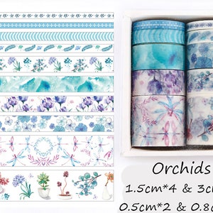 May include: A set of 10 washi tapes featuring floral and nature-inspired designs in shades of blue, purple, and pink. The tapes are packaged in a white box with the text "Orchids 1.5cm*4 & 3cm*2 0.5cm*2 & 0.8cm*2".