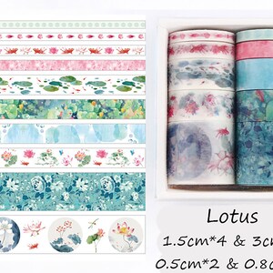 May include: A set of 10 washi tapes with watercolor designs featuring lotus flowers, leaves, and fish. The tapes are in a variety of widths, including 1.5 inches, 3 inches, 0.5 inches, and 0.8 inches. The tapes are packaged in a clear plastic box with the text "Lotus" and the dimensions of the tapes printed on the box.