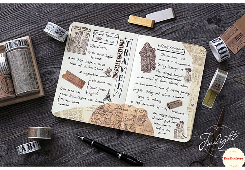 May include: A collection of decorative washi tapes with various patterns and designs, including a map, a vintage travel poster, and a floral pattern. The tapes are arranged on a wooden surface with a notebook and other stationery items.