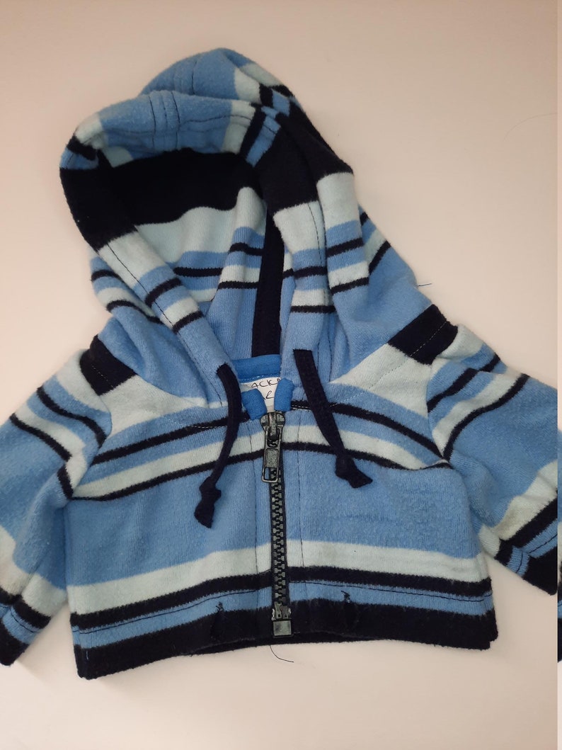 May include: Blue and navy striped fleece hooded jacket with a zipper closure.