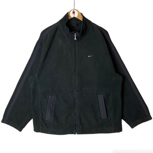 May include: Black fleece zip-up jacket with a silver Nike swoosh logo on the left chest and black stripes down the sleeves.