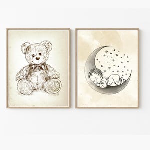 May include: Two black and white illustrations in frames. The first illustration shows a teddy bear sitting with a bow tie. The second illustration shows a baby sleeping in a crescent moon with stars.