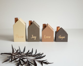May include: Four wooden houses with copper chimneys, each painted a different color and inscribed with the words "Peace", "Joy", "Love", and "Hope".