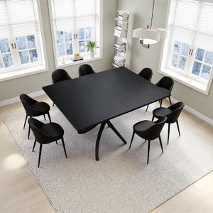 May include: A large square black dining table with a central pedestal base, surrounded by eight matching black chairs with curved backrests and thin metal legs. The furniture set is arranged in a bright room with windows and light flooring.
