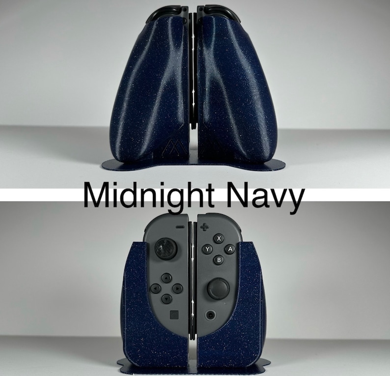 May include: A midnight navy blue 3D printed stand for two Nintendo Switch Joy-Con controllers. The stand is designed to hold the controllers upright and features a textured finish.