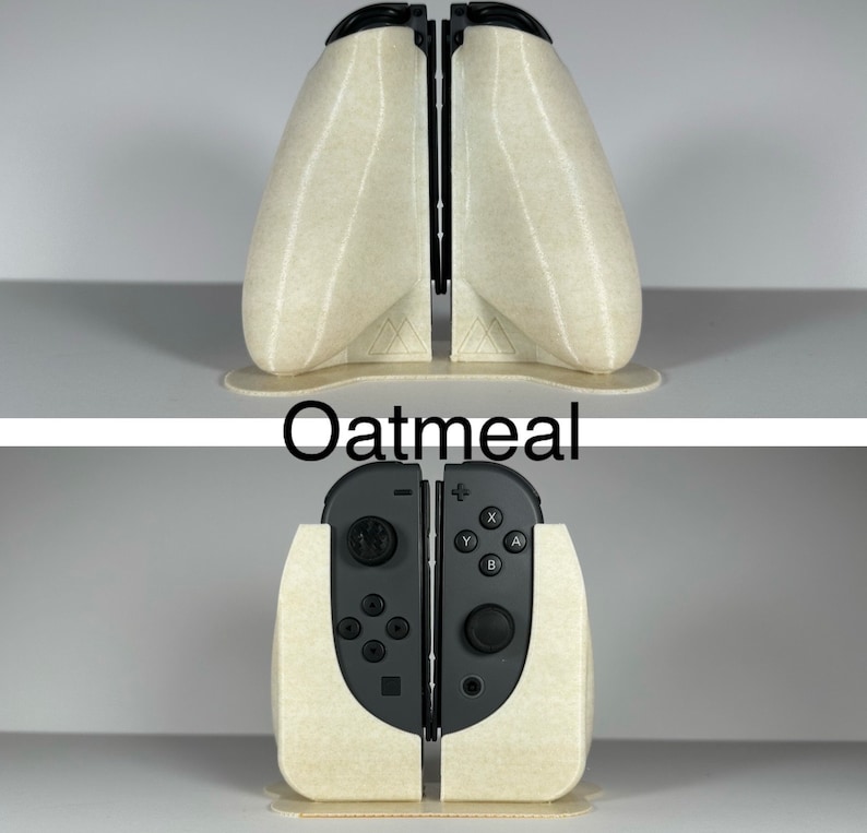 May include: A beige 3D printed stand for a Nintendo Switch console. The stand is designed to hold the console in a vertical position. The stand is labelled "Oatmeal".