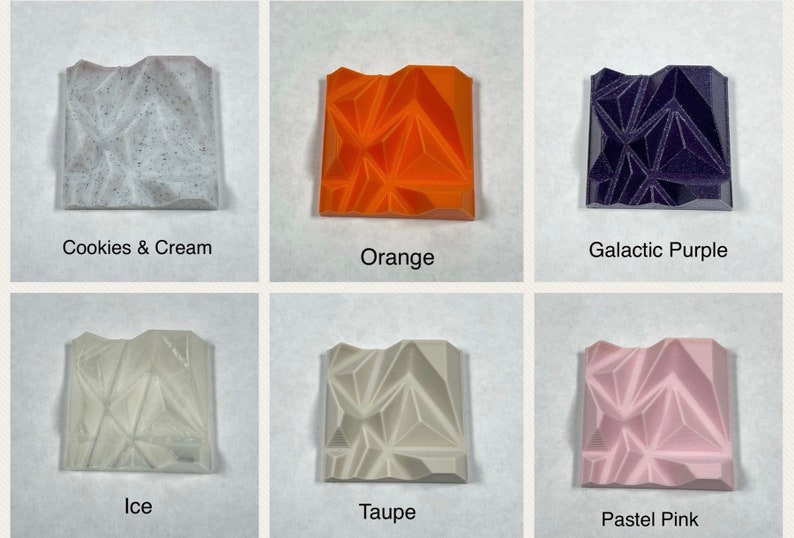 May include: Six small square tiles with different colours and textures. The tiles are arranged in two rows of three. The top row shows Cookies & Cream, Orange, and Galactic Purple. The bottom row shows Ice, Taupe, and Pastel Pink.