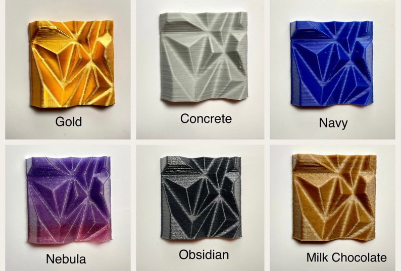 May include: Six small square tiles with a geometric pattern, each tile is a different colour: gold, concrete, navy, nebula, obsidian, and milk chocolate.