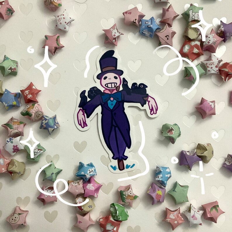 May include: A sticker featuring a cartoon character in a purple suit and top hat, with crows perched on its shoulders. The sticker is surrounded by colorful origami stars with various patterns. The background is white with heart shapes.
