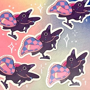 May include: A collection of stickers featuring a stylized crow with a patterned wing design in pink and blue. The crow has a pearl necklace and a teardrop. The background is a gradient of pink, blue, and yellow.