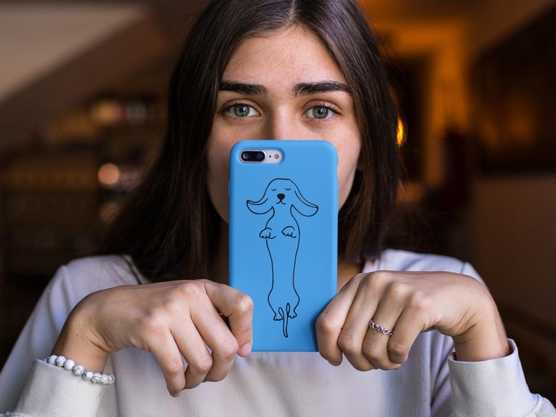 May include: A blue phone case with a black outline of a dachshund dog.