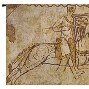 May include: A tapestry depicting a medieval knight on horseback, holding a spear and shield. The knight is wearing armor and a helmet, and the horse is adorned with a saddle and bridle. The tapestry is made of woven fabric and has a brown and beige color scheme.