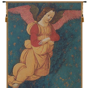 May include: A tapestry featuring a painting of an angel with pink wings, wearing a red and yellow robe, kneeling on a blue and green background with gold stars.