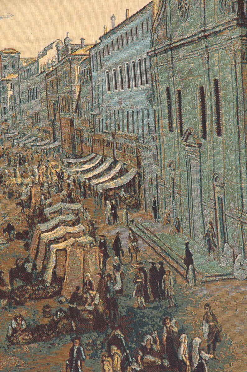 May include: A tapestry depicting a bustling street scene in a European city. The street is lined with buildings, some with arched doorways and windows. There are many people walking and shopping in the street, and there are also some horse-drawn carriages. The tapestry is woven in a variety of colors, including browns, greens, and blues.