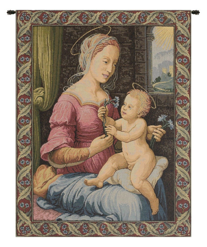 May include: A tapestry depicting the Madonna and Child. The Madonna is wearing a pink dress and a blue robe. She is holding a bouquet of flowers. The Child is sitting on her lap and is also holding a bouquet of flowers. The tapestry has a burgundy border with a green and blue floral design.