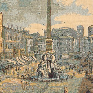 May include: A tapestry depicting a bustling city square with a tall obelisk in the center. The square is filled with people, some walking, some shopping at stalls, and others gathered around a fountain. The buildings surrounding the square are a mix of old and new, with a variety of architectural styles.