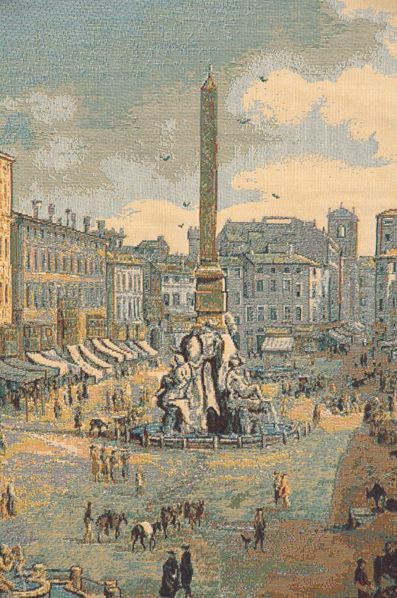 May include: A tapestry depicting a bustling city square with a tall obelisk in the center. The square is filled with people, some walking, some shopping at stalls, and others gathered around a fountain. The buildings surrounding the square are a mix of old and new, with a variety of architectural styles.