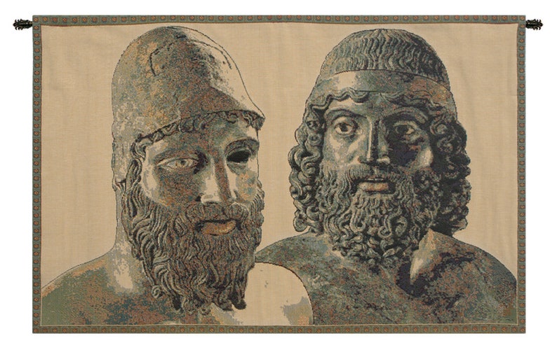 May include: A tapestry with two faces of men with beards. The men are depicted in a green and brown color scheme. The tapestry has a beige background and a green and brown border.