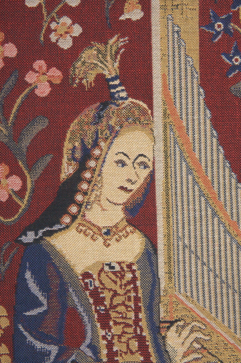 May include: A tapestry featuring a woman in a blue and gold dress playing a harp. The tapestry has a red background with floral designs.