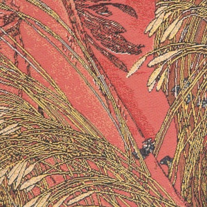 May include: A close-up of a red fabric with a woven pattern of yellow and brown leaves. The fabric has a textured surface and a vintage look.
