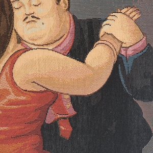 Op de afbeelding: Wandtapijt met een stel dat de tango danst. De man, in een zwart pak met een roze stropdas en boord, houdt de arm van de vrouw vast. De vrouw draagt een rode jurk. Het kunstwerk heeft een gepixelde, geweven textuur.