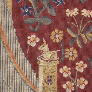 May include: A tapestry with a red background featuring a unicorn on a column, surrounded by floral designs in shades of blue, yellow, and white.