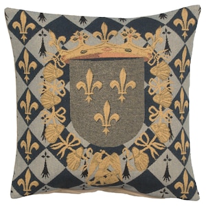 May include: A decorative throw pillow with a tapestry design featuring a royal crest with a crown and three fleurs-de-lis on a gray shield. The crest is surrounded by a wreath of gold leaves and flowers. The background is a blue and white checkered pattern.
