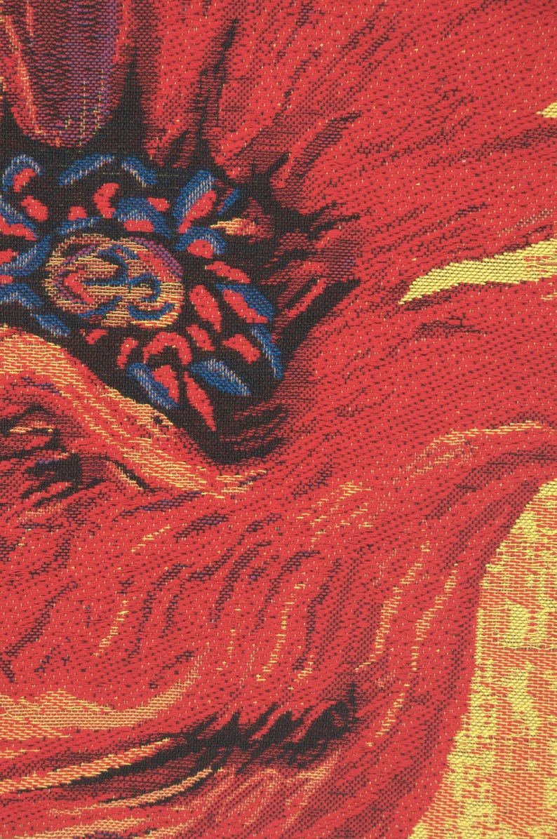 May include: Close-up of a red poppy flower with a textured woven fabric design. The flower is in focus, with the background blurred.