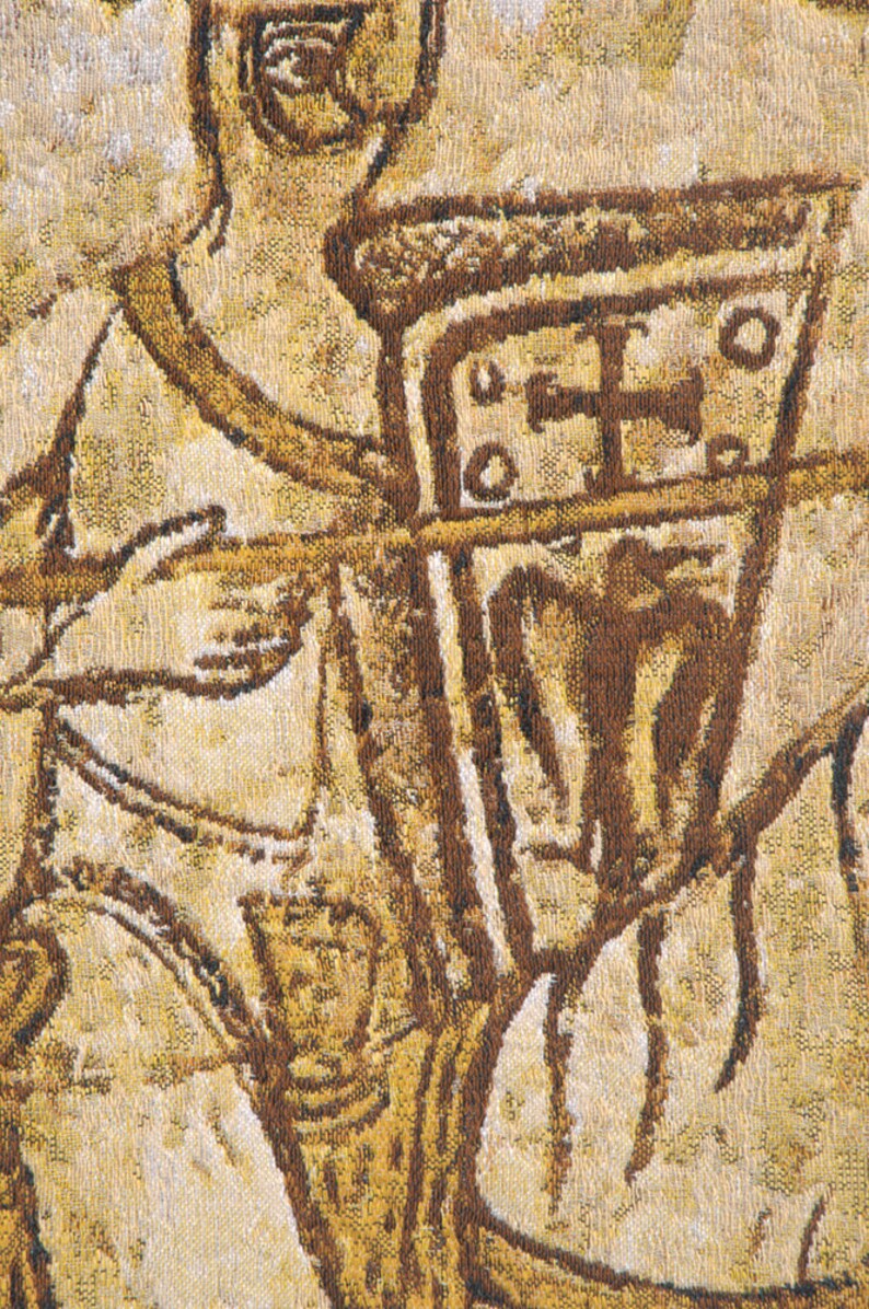 May include: Close-up of a tapestry depicting a figure in armor holding a shield with a cross. The tapestry is woven with brown and gold threads, creating a textured effect.