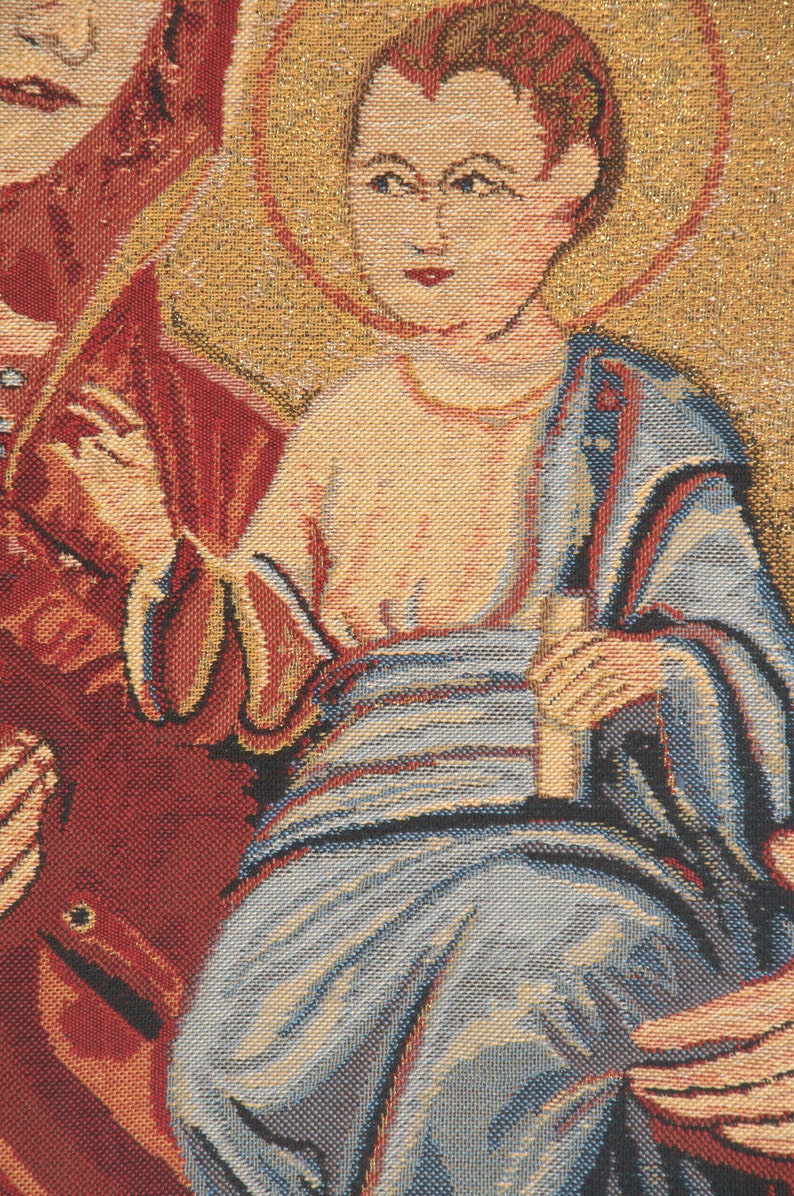 May include: A tapestry depicting a religious scene with a central figure of a young boy wearing a blue robe and holding a book. The boy is surrounded by two other figures, one on each side, with the figure on the left wearing a red robe.