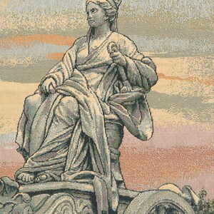 May include: A tapestry depicting a woman in a flowing robe, seated on a chariot with large wheels. The tapestry has a muted color palette of beige, brown, and green.