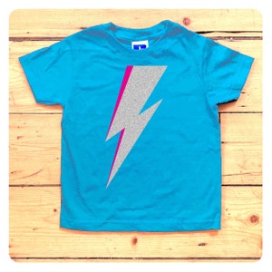 Turquoise t-shirt with silver glitter and neon pink lightning bolt