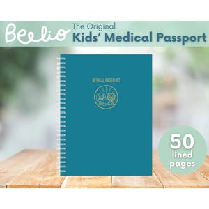 May include: A teal spiral-bound notebook titled "The Original Kids' Medical Passport" with the Beelio logo. The cover features a gold emblem and the text "MEDICAL PASSPORT". The notebook has 50 lined pages.