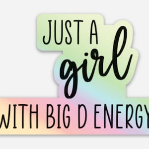 May include: A sticker with a rainbow gradient background and the text "Just a girl with big D energy" in black.
