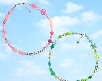 May include: Two beaded necklaces with colorful charms and letter beads spelling out "Bubblegum" and "Gumball".