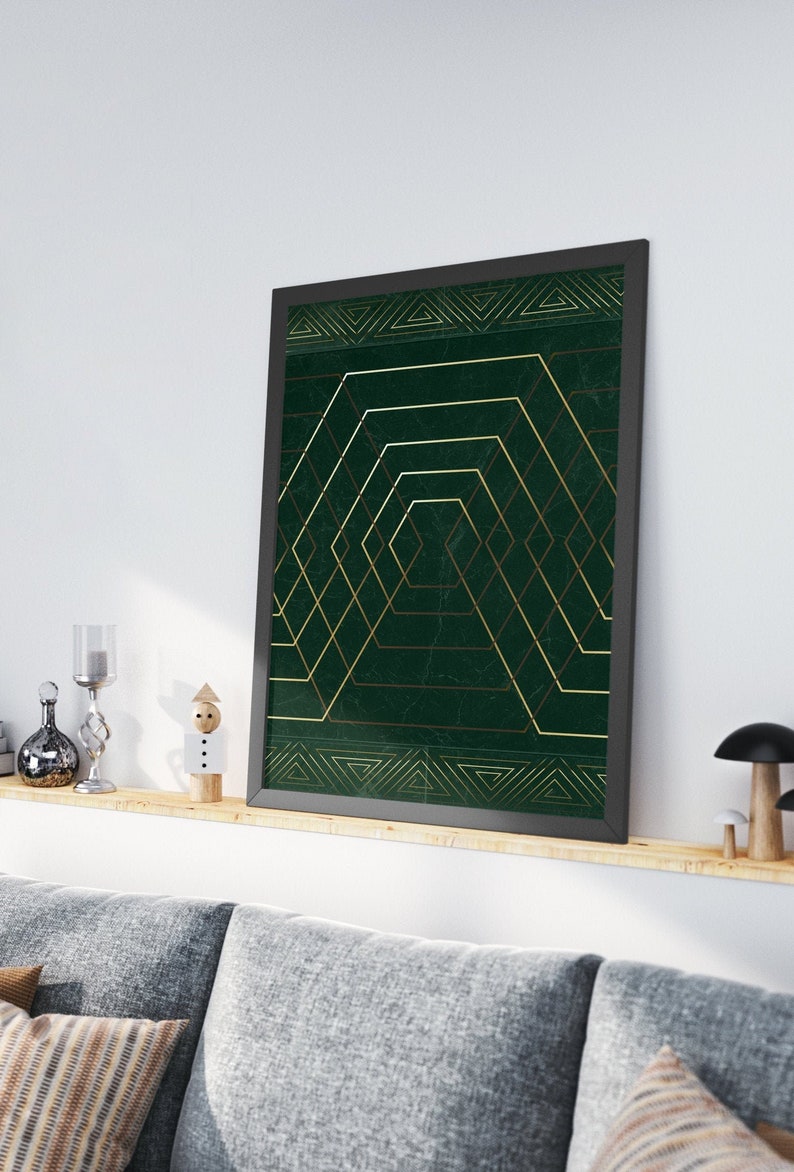 May include: A framed print with a geometric design featuring gold lines on a dark green background.
