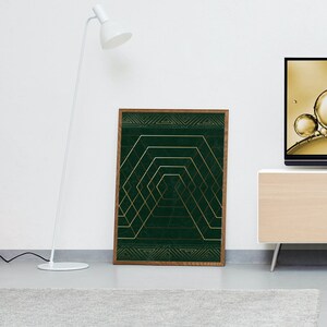 May include: A framed print with a geometric design featuring gold lines on a dark green background.