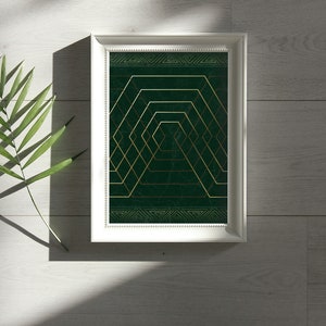 May include: A framed print with a geometric design in gold and green. The design features a series of overlapping squares and hexagons, creating a sense of depth and perspective.