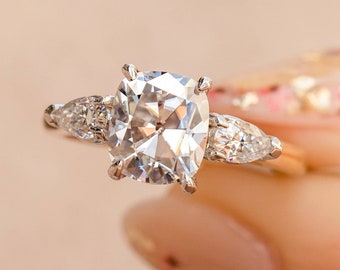 Cushion cut diamond with pear side stones best sale