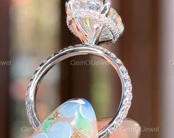 May include: A diamond engagement ring with a large oval-cut central stone and a halo of smaller diamonds. The ring's band is also set with diamonds, creating a brilliant sparkle. The ring is a symbol of commitment.