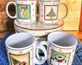 May include: Set of four white ceramic Christmas mugs with festive holiday designs. The mugs feature a stocking, a Christmas tree, a snowman, and a sleigh with a Christmas tree. The mugs are packaged in a box with the text "Happy Holidays" and "Stoneware Mugs".